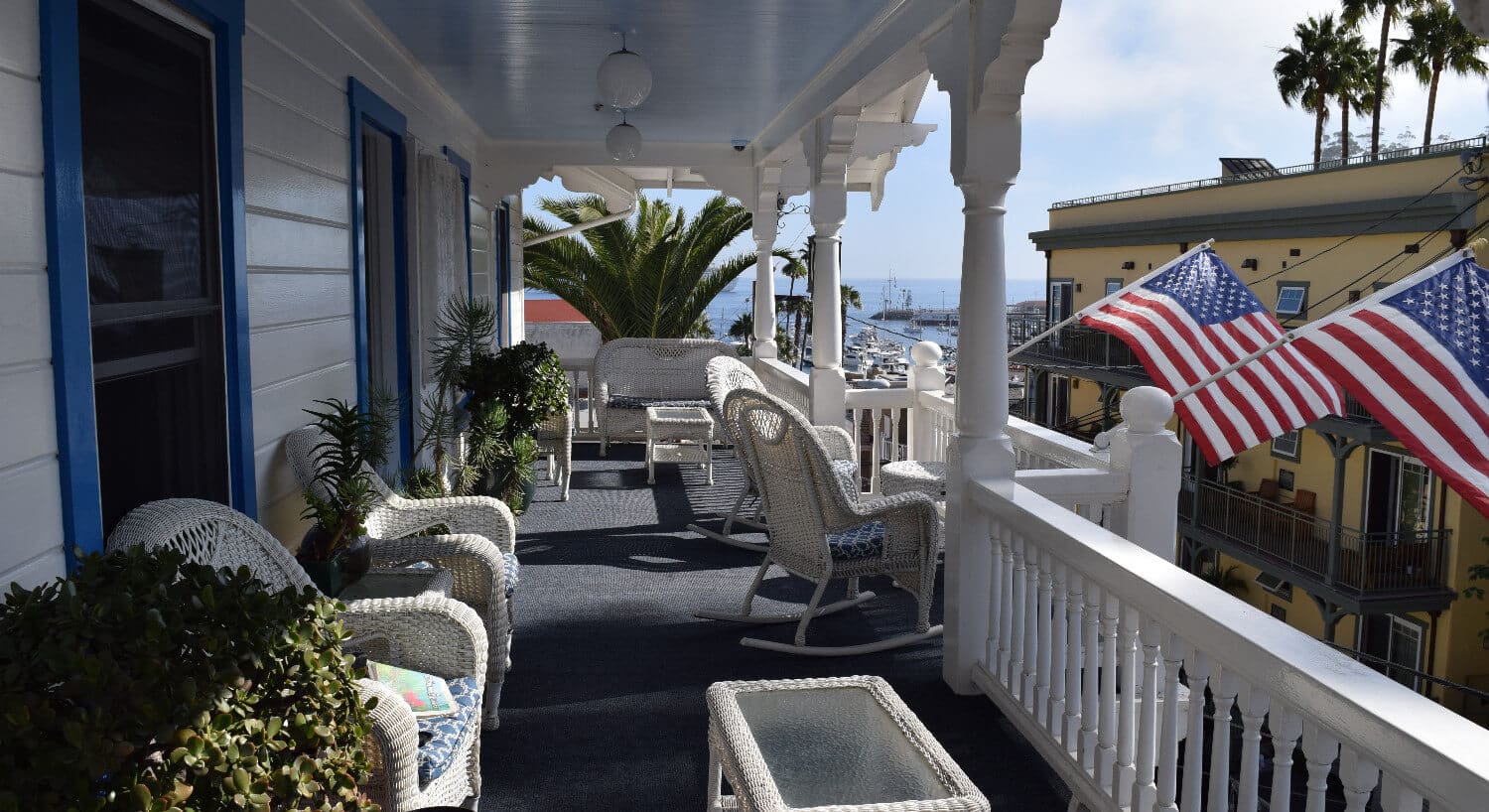 with wicker rocking chairs overlooking ocean view.