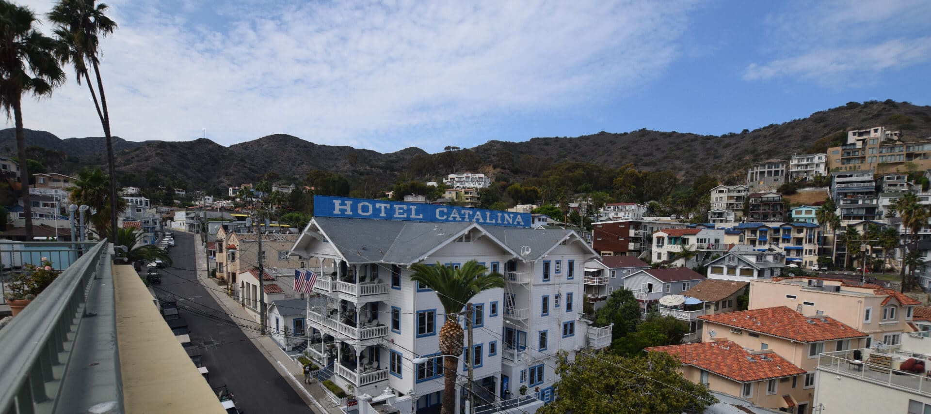 Overhead view of large white building with a blue sign saying Hotel Catalina
